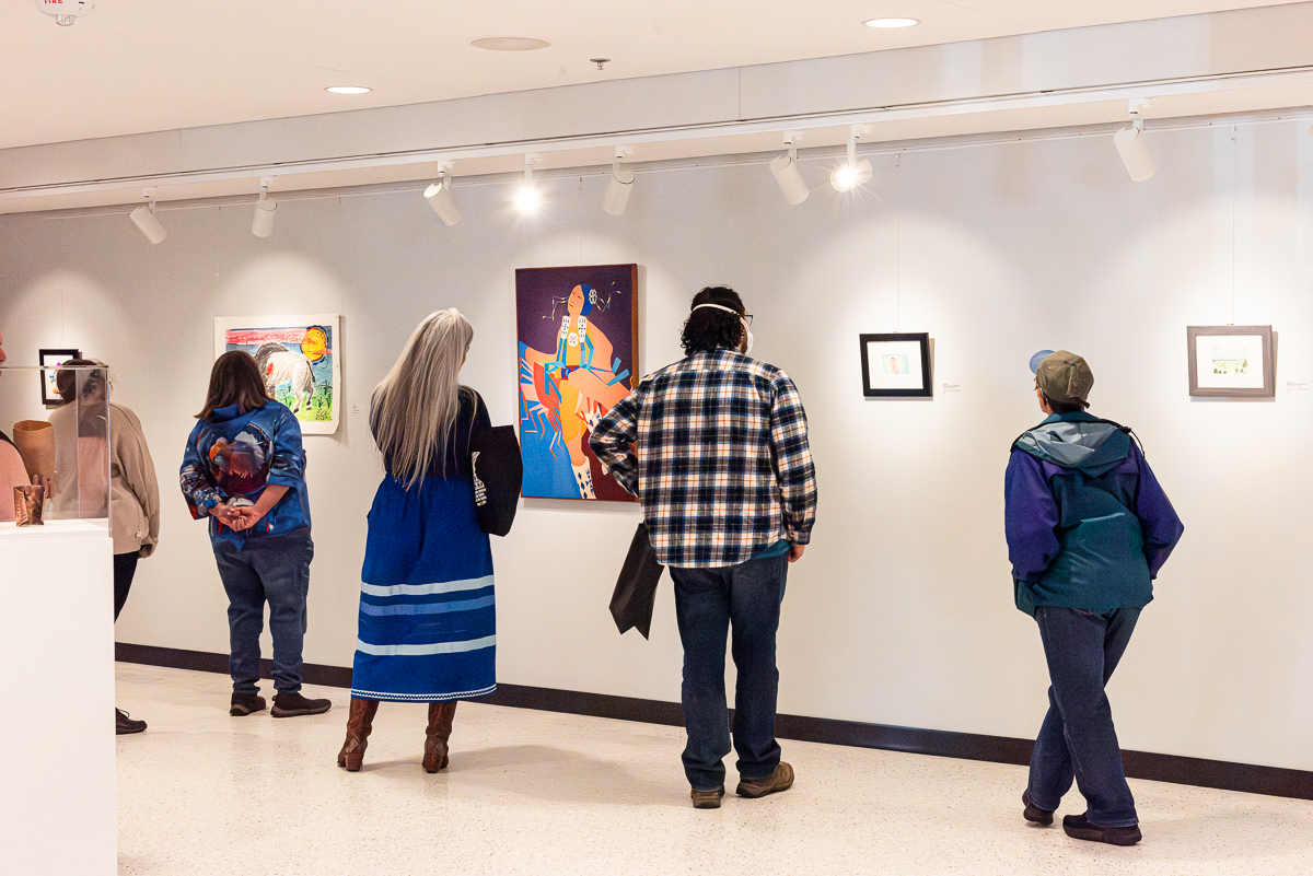 Community members view art in a gallery.