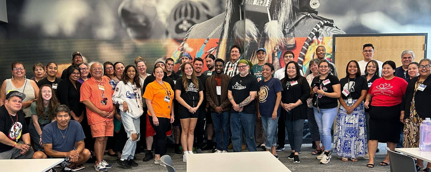 About 50 Minneapolis American Indian Center staff members, who are majority Native, pose for a photo.